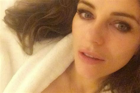 Elizabeth Hurley Bares Her Chest Wearing Just A Robe In A Very Sexy