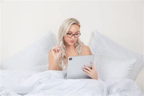 Blonde Girl In Bed With White Pillows And A Blanket In A Bright Bedroom Stock Image Image Of