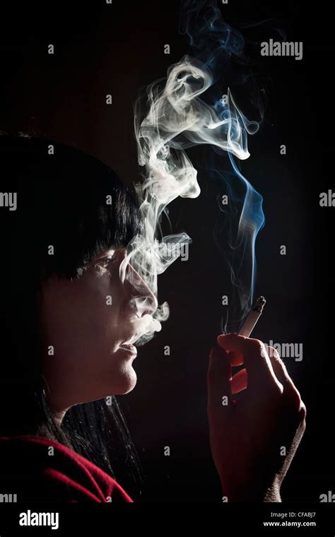 Illuminated Profile Of Woman Smoking Stock Photo Alamy