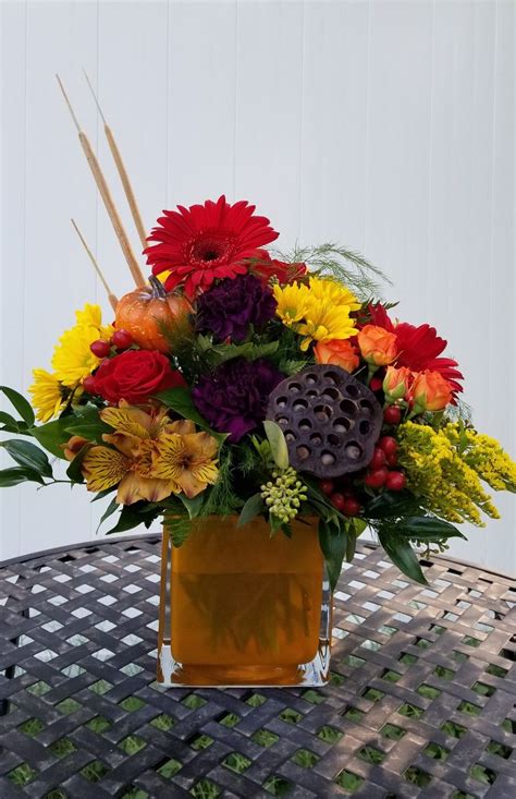 This beautiful floral basket arr. This large fall glass cube comes in yellow, plum and navy ...