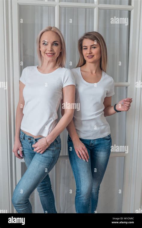 Two Charming Blondes In White T Shirts And Jeans Mockup For Typography