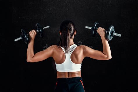 Athletic Young Woman Doing A Fitness Workout Against Black Background