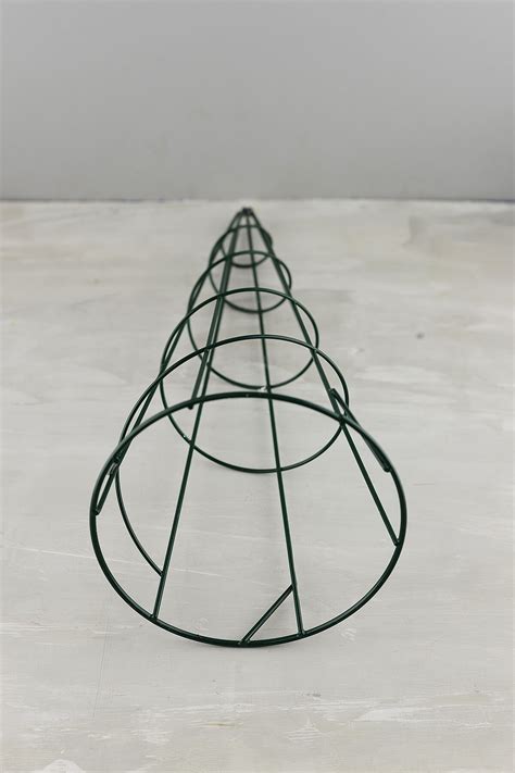 Topiary is the horticultural practice of training perennial plants by clipping the foliage and twigs of trees, shrubs and subshrubs to develop and maintain clearly defined shapes, whether geometric or fanciful. 15" Wire Topiary Cone