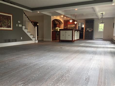 Gray hardwood floor feat beautiful gallery wall. Custom finished hardwood flooring - Minneapolis, MN ...