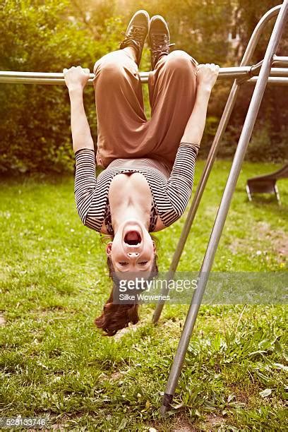 Girl Hanging Upside Down In A Playground Stock Fotos Und Bilder Getty
