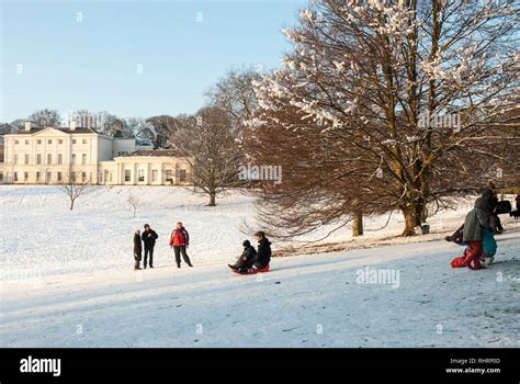 On A Snowy Winters Day Families Sledge Down Slopes In Front Of Kenwood