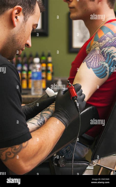 Tattoo Artist At Work Stock Photo Alamy
