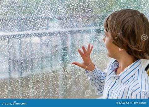 Smiling Boy Watching The Rain Outside At A Window Stock Image Image
