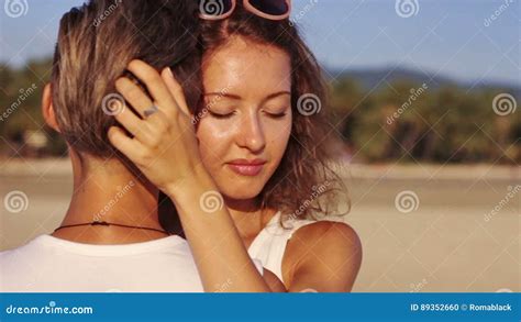Young Couple Embracing Together On The Beach Stock Footage Video Of