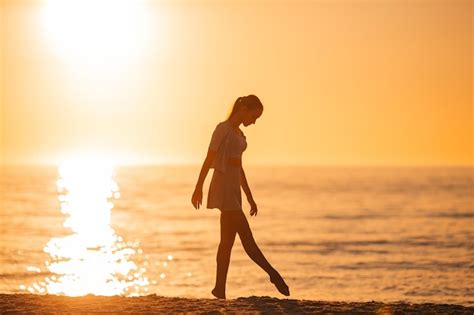 Premium Photo Silhouette Of The Beautiful Girl Enjoying Beautiful Sunset On The Beach