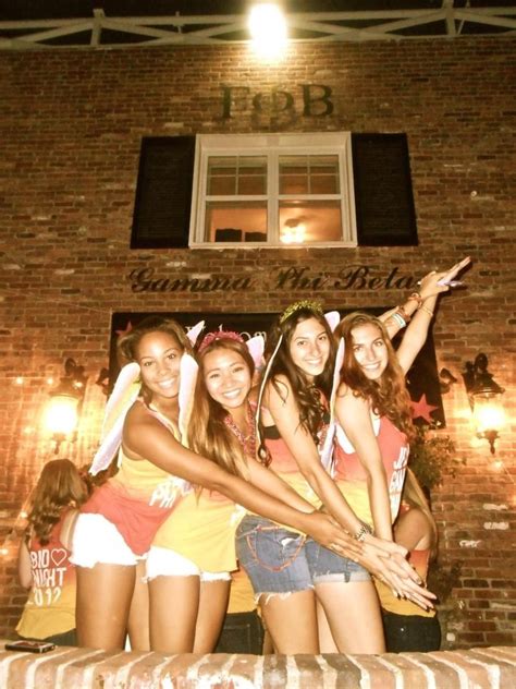 Four Girls Are Posing For A Photo In Front Of A Brick Building With