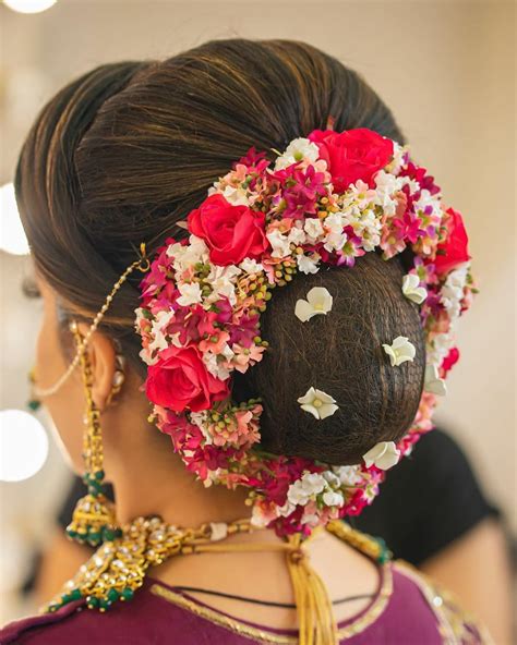 Dutch braids combined with a low messy bun as you may know already, there are two different types of messy buns you can opt for: Floral blooms | Bridal bun, Bridal hair buns, Indian bridal hairstyles