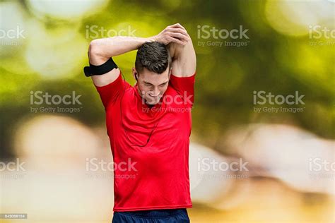 Smiling Male Runner Stretching Outdoors Stock Photo Download Image