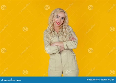 Portrait Of A Joyful And Cheerful Cute European Curly Haired Blonde Woman Who Jokes Cheerfully