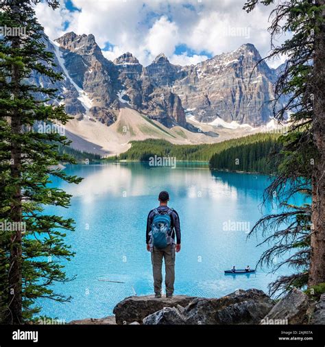 Hiker Enjoying The View At Moraine Lake During Summer In Banff National