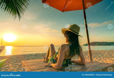 Sexy Enjoy And Relax Woman Wear Bikini Lying And Sunbathing On Sunbed