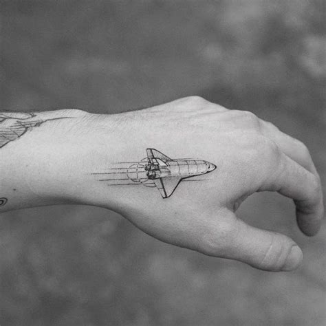 Single Needle Space Shuttle Tattoo On The Left Hand
