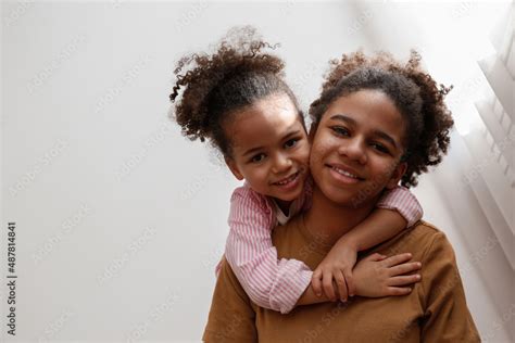 Younger And Older Sister Spending Time Together At Home Two Black
