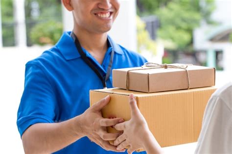 Premium Photo Delivery Man Holding Parcel Box Give To Customer