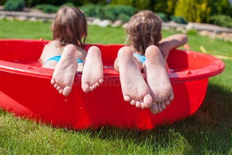 Close Up Of Feet Two Sisters In Small Pool Stock Image Image Of