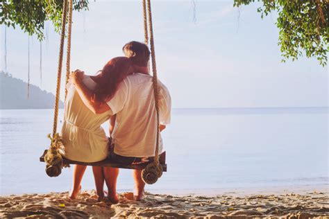 Romantic Holidays Honeymoon Affectionate Couple On Beach On Swing