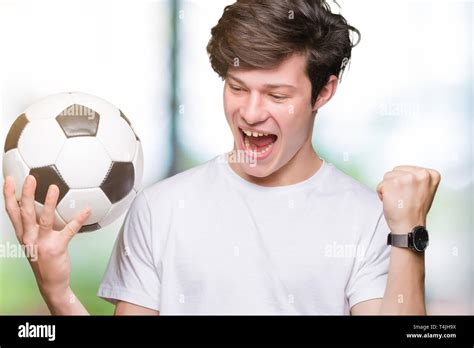 Young Man Holding Soccer Football Ball Over Isolated Background