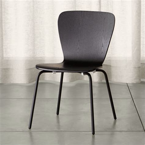 Featuring classic tapered legs and a curved wood back that transitions into subtle arm rests. Felix Black Dining Chair + Reviews | Crate and Barrel