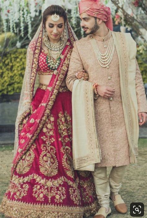 Luxurious Bridel Groom Dress In Red Lahnga Choli And Pinkish Sherwani
