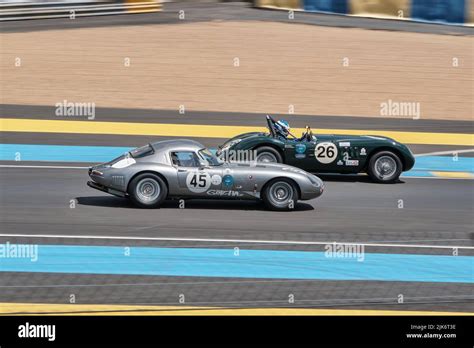 Two Race Cars Driving From Left To Right On A Racetrack Stock Photo Alamy