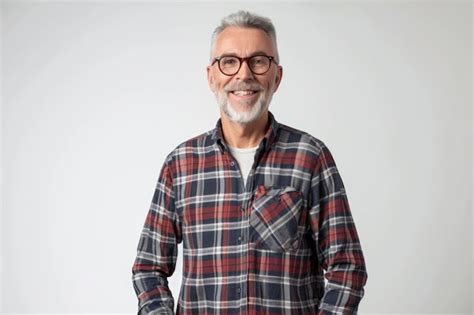 Premium Photo Portrait Of Smiling Mature Man Standing On White Background