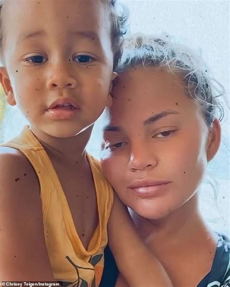 Chrissy Teigen Showcases Her Figure In A Floral Bikini And Puts On A