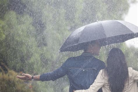 Couple Walking Under Umbrella In Rain Stock Image F0140535 Science Photo Library