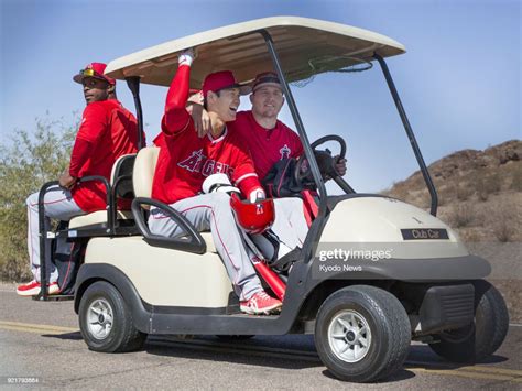 The Los Angeles Angels Mike Trout Drives A Cart Beside Rookie Shohei