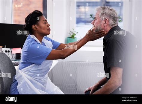 Female Doctor Examining Patients Neck Stock Photo Alamy