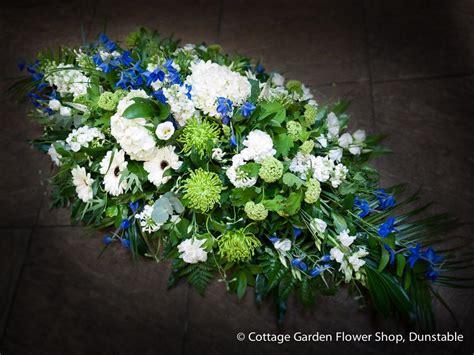 Casket sprays arranged by a local florist, with seasonal flowers. Blue, White & Green Casket Spray | Casket flowers, Casket ...