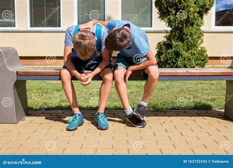 Kid Comforting Consoling Upset Sad Boy In School Yard Stock Photo