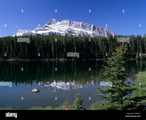 Johnson Lake With Snowy Peak Of Mount Rundle Reflected In The Water