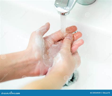 Close Up Of Kid Hands Under Stream Of Water From Faucet Stock Image