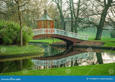 Park Zone With River And Bridge Surround By Green Grass Field And Trees