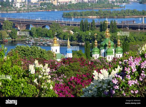 Spring View Of Vydubychi Monastery And Dnipro River With Lilac Blossom