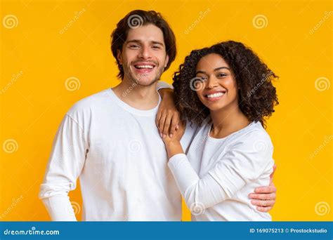 Romantic Multiracial Couple Embracing Posing Together And Smiling At Camera Stock Image Image