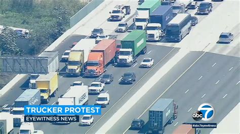 Truckers Stage Convoy Protest Around Ports Of La Long Beach Over