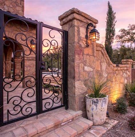 Beautiful Gates And Stone Wall Leading To Courtyard Fence Design