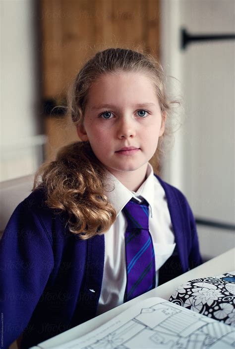 Schoolgirl Sitting At The Table After School By Christina K Stocksy
