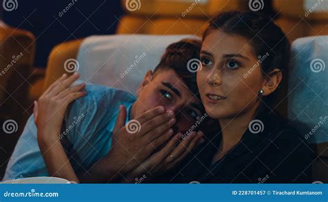 Attractive Cheerful Young Caucasian Woman Watching Horror Movie In Cinema Theater Lifestyle