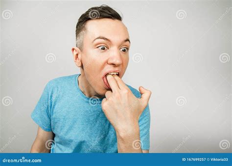 Young Guy Inserts Two Fingers In The Mouth To Induce Vomiting On A
