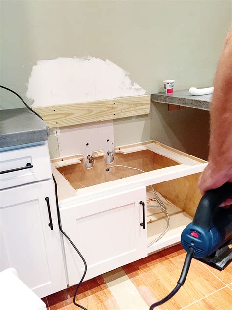 Place a drop cloth or piece of cardboard on the floor in front of the appliance to avoid marring the floor. Retrofitting a Cabinet for a Farm House Sink - Bower Power