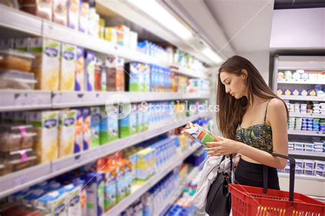Young Woman Shopping For Fruits And Vegetables In Produce Department Of