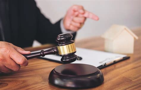 Premium Photo Midsection Of Lawyer Holding Gavel On Table