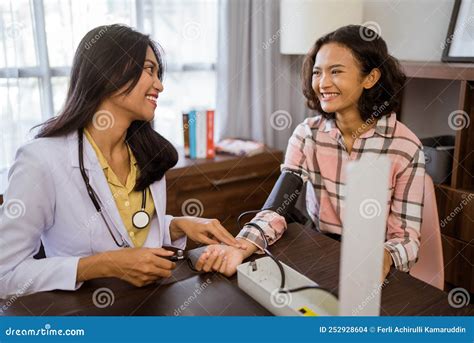Female Doctor Chatting With Female Patient While Using A